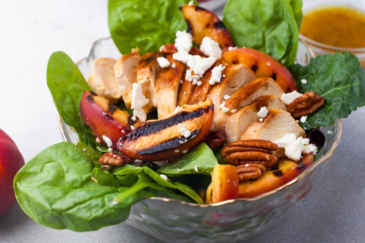 Grilled Peach Salad with Chicken served in a bowl.