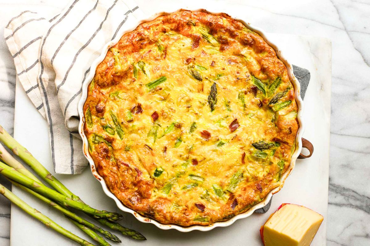 11 “Poor Man’s” Meals That Tasted Better Than Fancy Restaurant Food 9 Leek and Bacon Frittata with Asparagus overhead view.