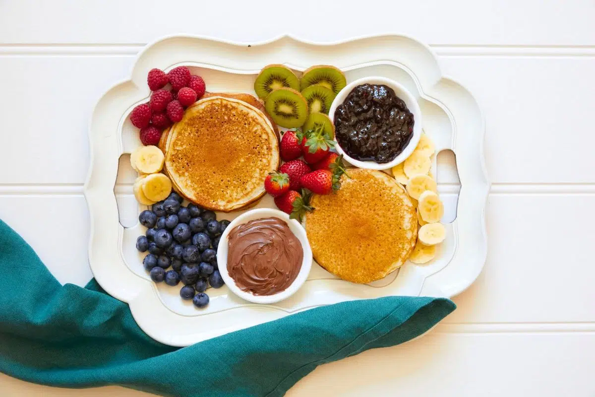Pancakes served with fruits.