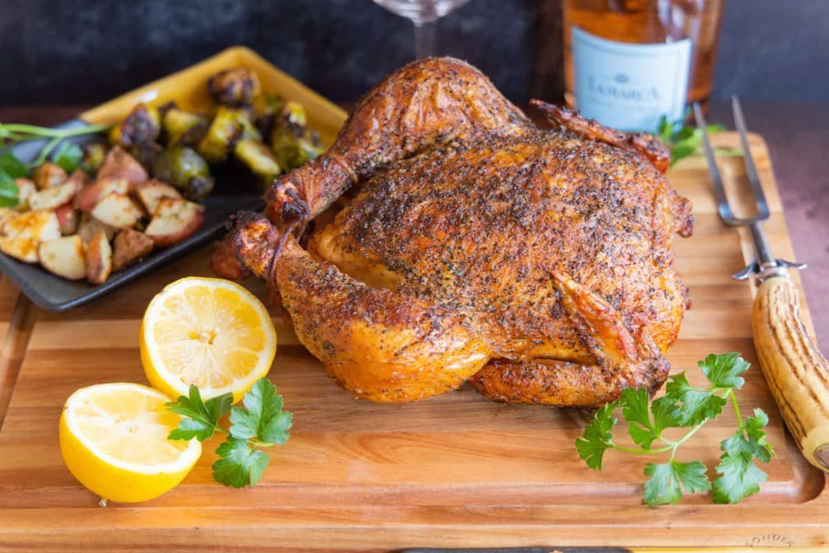 Smoked Whole Chicken on a chopping board.