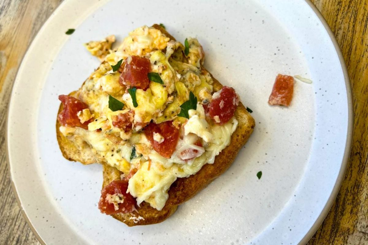 Tomato and Feta Scrambled Eggs served on a plate.