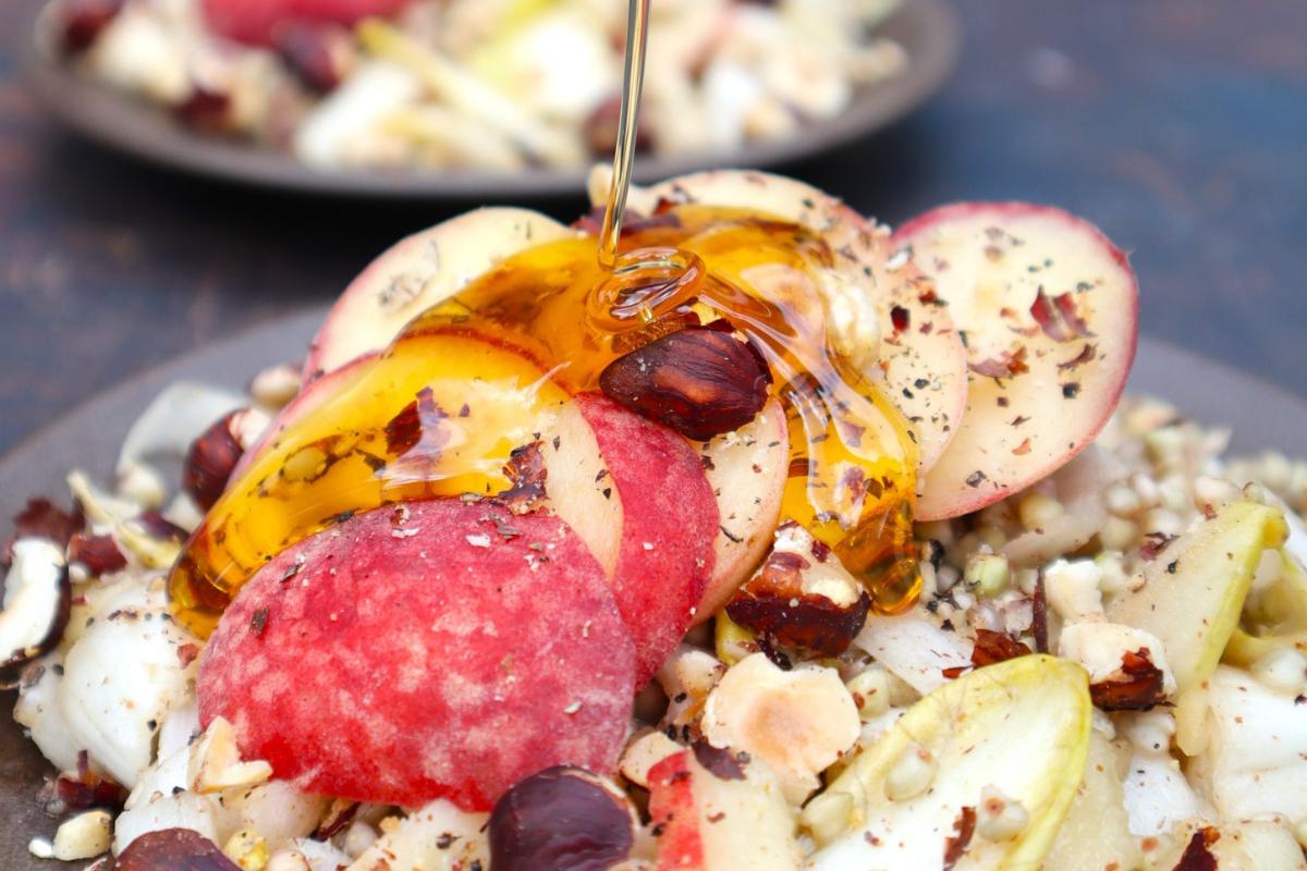 A chicory salad with peaches and hazelnut.