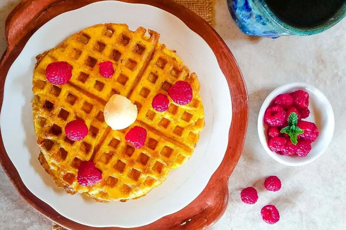 Keto Waffles topped with raspberries.