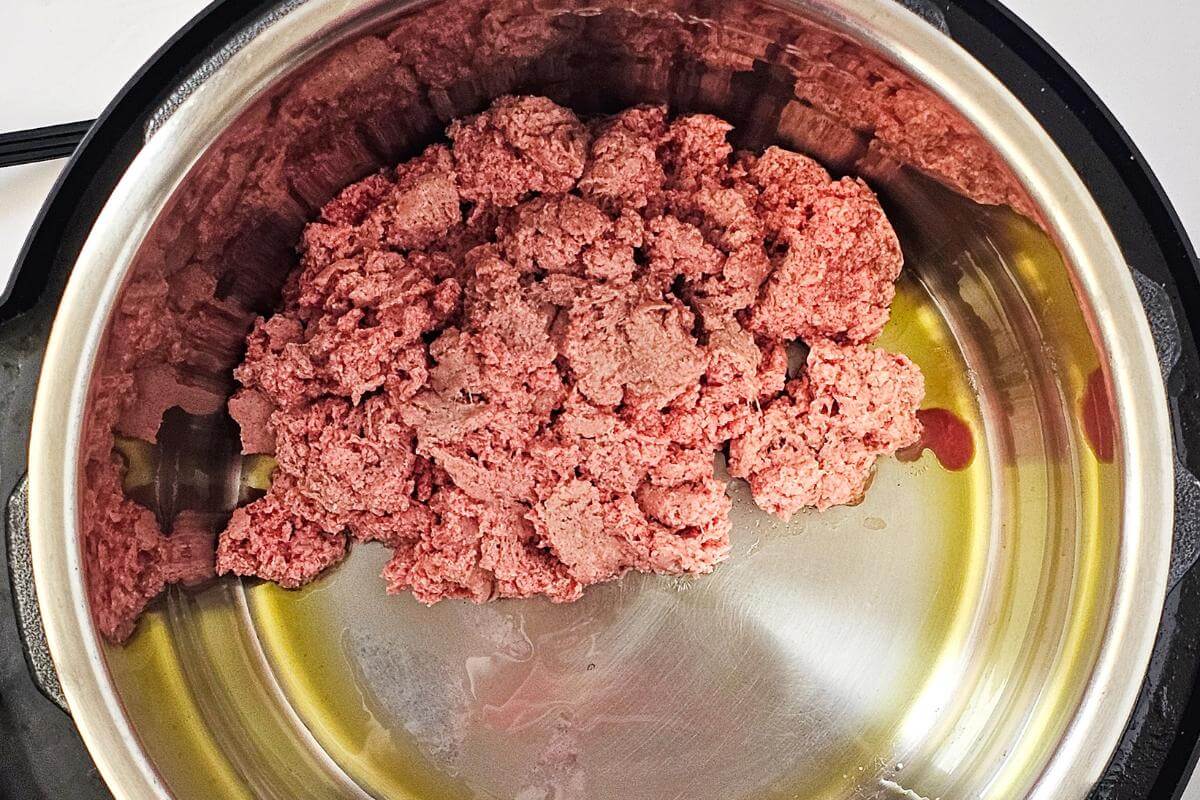 Raw ground turkey in a pot.