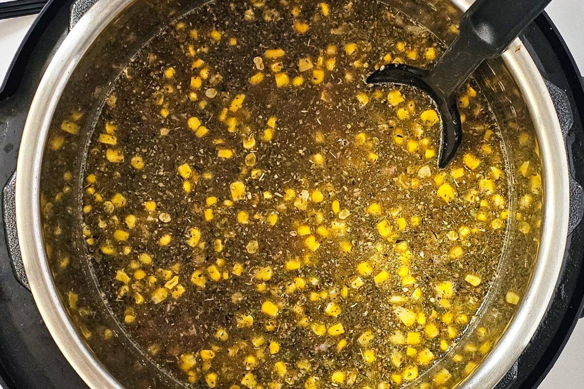 Ingredients for making white turkey chili mixed together in a pot.