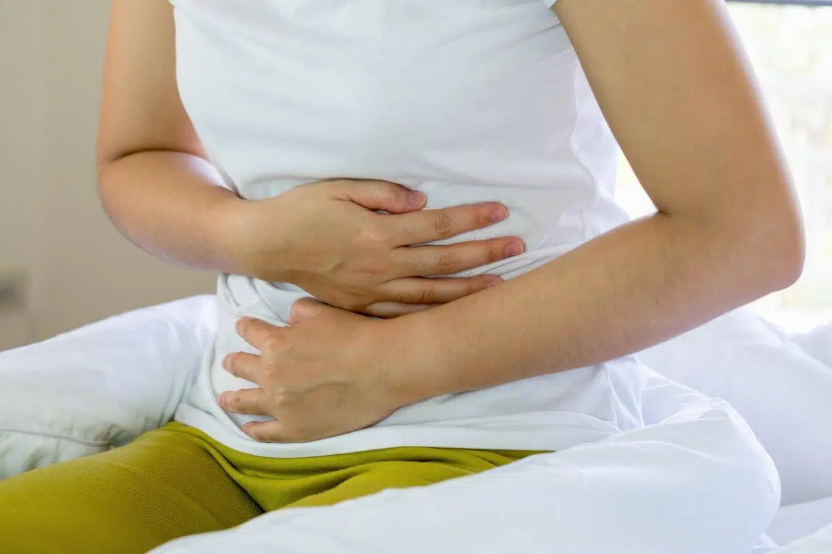 A woman holding her stomach.