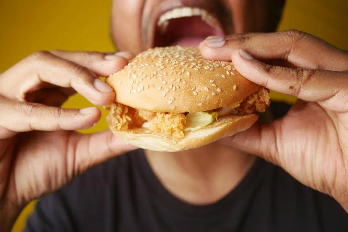 A man eating a chicken sandwich.
