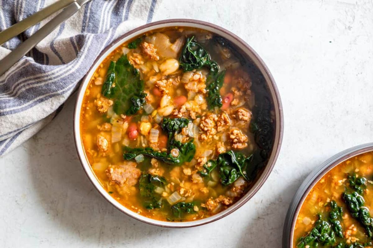 Instant Pot Sausage Bean and Kale Soup served in a bowl.