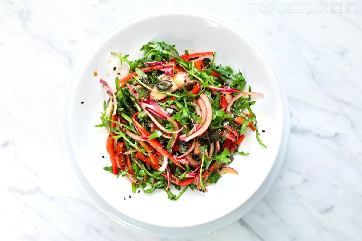 Arugula Salad and Balsamic Vinaigrette on a plate.
