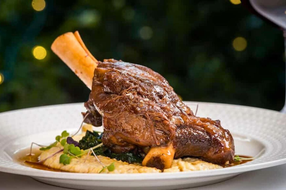 Braised Lamb Shanks with Creamy Polenta served on a plate.