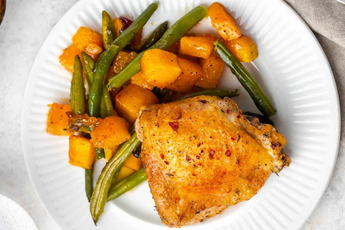 Sheet Pan Chicken Thighs with Roasted Veggies on a plate.