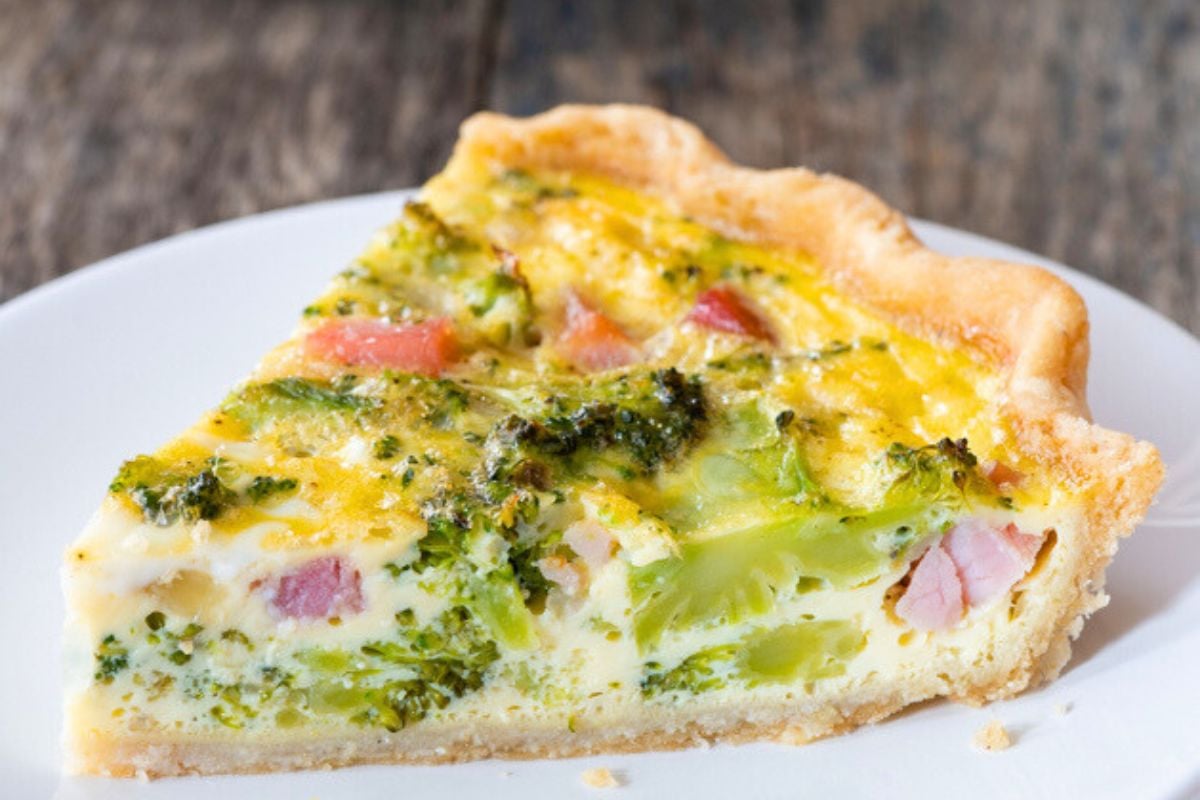 A slice of Gluten Free Quiche Recipe with Ham served in a plate.