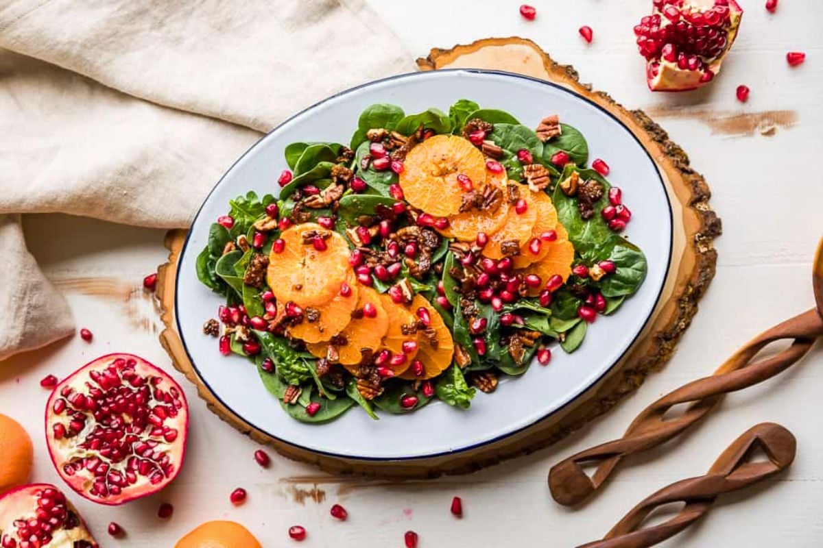 Spinach Salad with Mandarin Oranges and Warm Bacon Dressing on a plate.