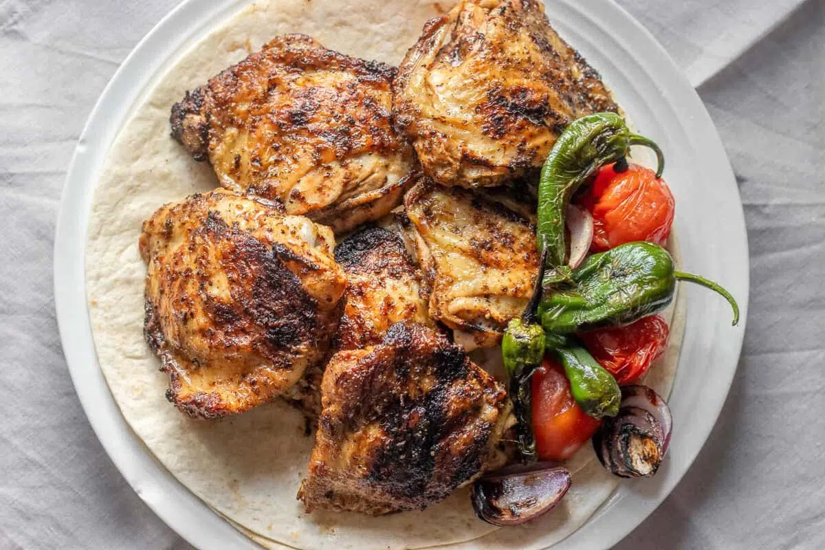 Grilled BBQ Chicken Thighs served on a plate.
