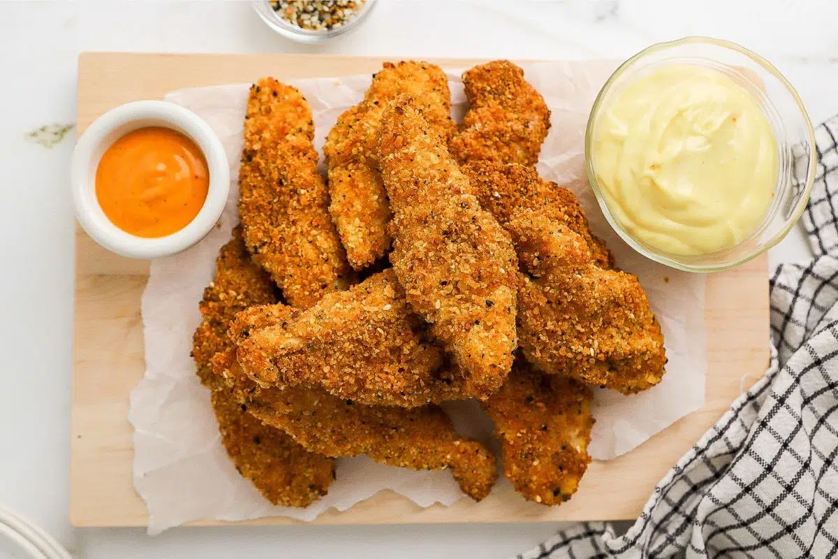 Air Fryer Gluten-Free Chicken Tenders served on a wooden board.