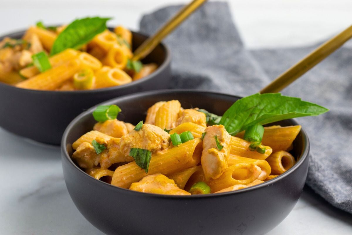 Chicken Curry Pasta topped with basil leaves.