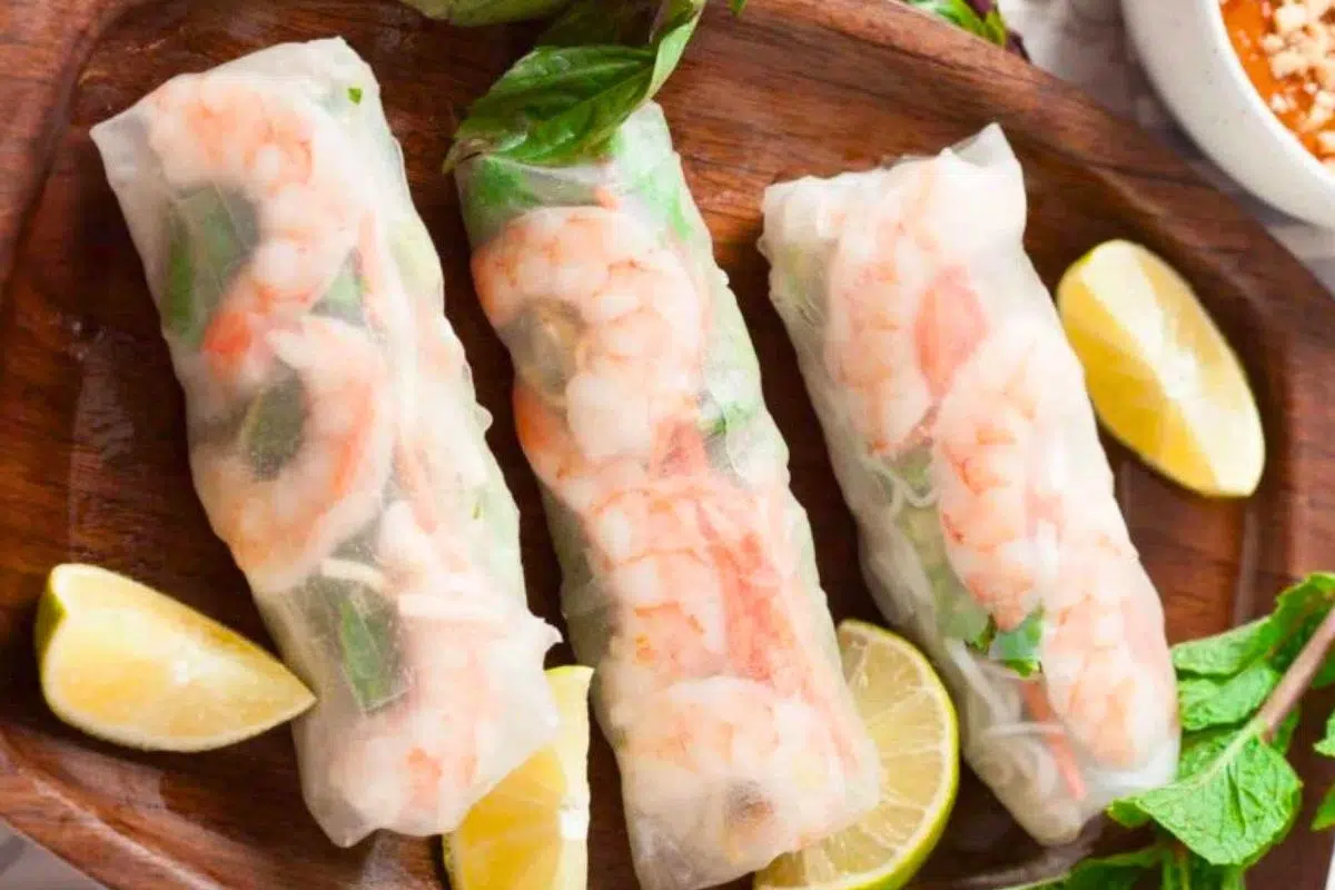 Vietnamese Spring Rolls served on a wooden plate.