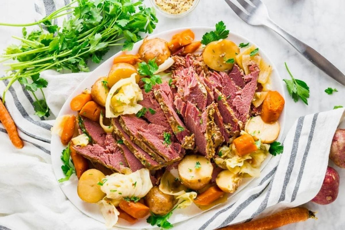 A plate of Slow Cooker Corned Beef with vegies.
