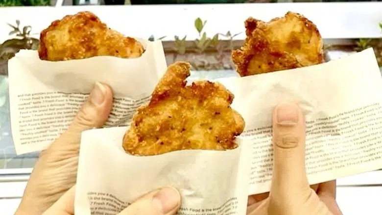 Three hands holding up nana chiki from 7-Eleven