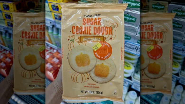 hand holding a package of Trader Joe's sugar cookie dough with pumpkin imprint